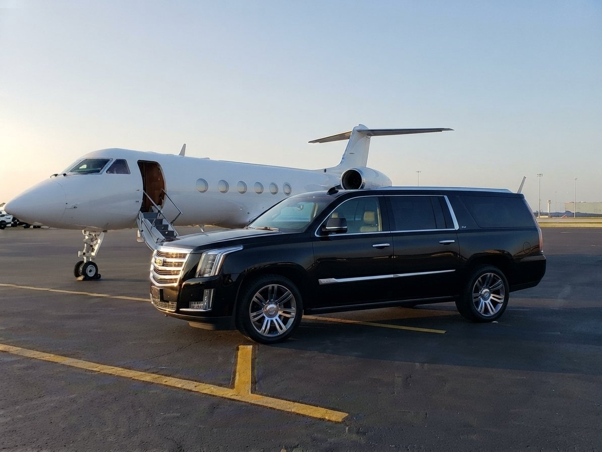 FXE Airport car service with black luxury SUV parked by a private jet on the tarmac