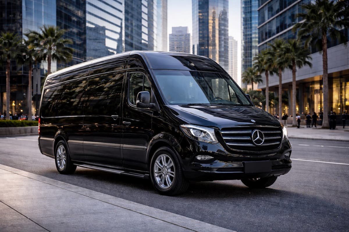 Luxury Sprinter van service with black Mercedes van parked on city street with skyscrapers