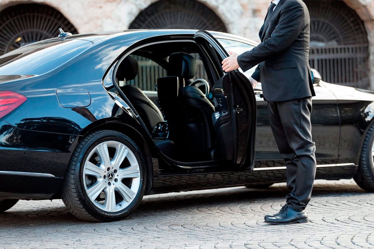 Weston Car Service with professional chauffeur opening luxury sedan door