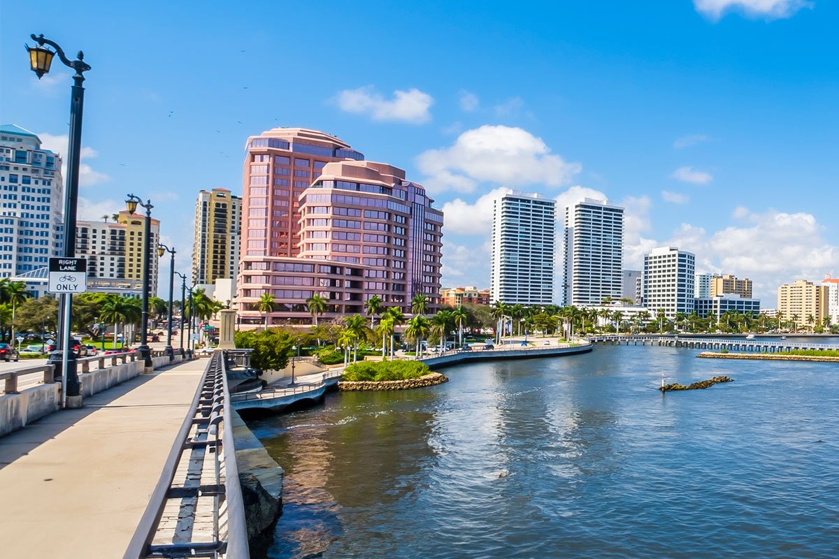 West Palm Beach car service with scenic view of downtown city skyline and waterfront bridge