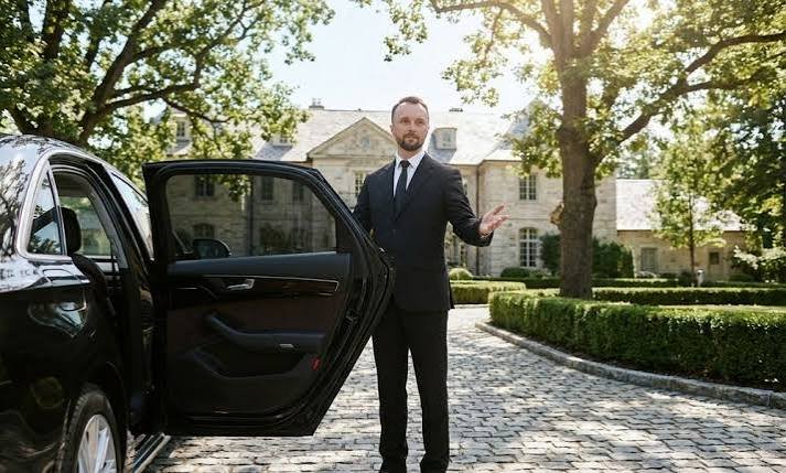 Corporate car service with professional executive chauffeur and luxury sedan