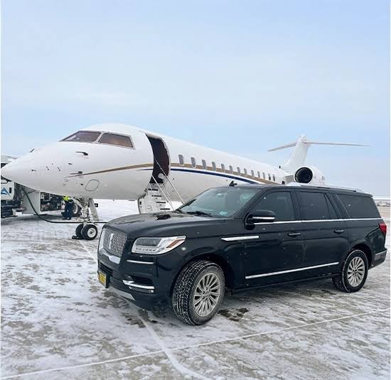 Corporate roadshow transport with luxury SUV and private jet on snowy tarmac