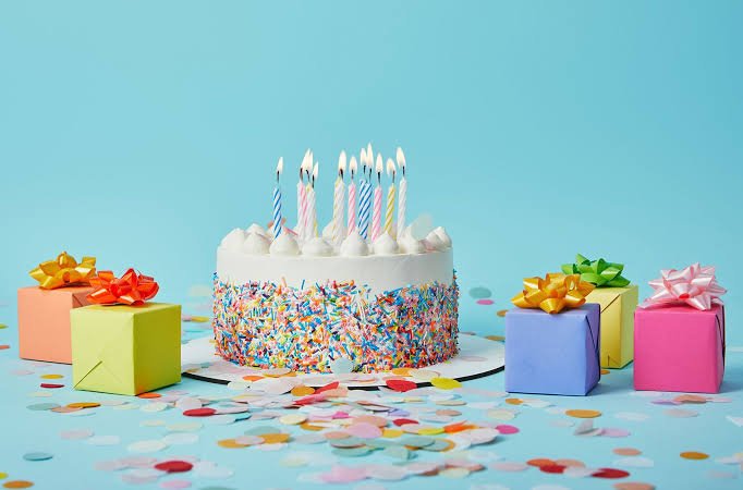 Birthday party limo service celebration with frosted cake and colorful gift boxes
